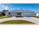 Well-maintained single-story home with a two-car garage and a curved driveway at 21269 Edgewater Dr, Port Charlotte, FL 33952