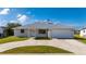 Charming single-story home with a well-manicured lawn and a two-car garage at 21269 Edgewater Dr, Port Charlotte, FL 33952