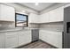 Spacious kitchen featuring stainless steel appliances, white cabinetry and wood floors at 21269 Edgewater Dr, Port Charlotte, FL 33952