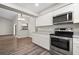 Open-concept kitchen with stainless steel appliances, wood floors and adjacent dining area at 21269 Edgewater Dr, Port Charlotte, FL 33952