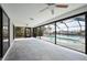 Enclosed lanai showcasing the pool, waterfront view, and ceiling fans at 21269 Edgewater Dr, Port Charlotte, FL 33952