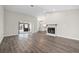 Spacious living room featuring hardwood floors, a fireplace, and open access to other rooms at 21269 Edgewater Dr, Port Charlotte, FL 33952