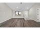 Open-concept living space with hardwood floors, a large window, and neutral paint at 21269 Edgewater Dr, Port Charlotte, FL 33952