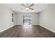 Bright living room featuring wood-look flooring, a ceiling fan, and a view of the screened patio at 21269 Edgewater Dr, Port Charlotte, FL 33952