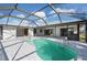 A kidney-shaped pool in screened lanai provides access to the house and great water views at 21269 Edgewater Dr, Port Charlotte, FL 33952