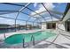 A kidney-shaped pool with a screened enclosure overlooks the canal at 21269 Edgewater Dr, Port Charlotte, FL 33952