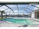 This kidney-shaped pool in screened lanai provides water views at 21269 Edgewater Dr, Port Charlotte, FL 33952