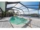 Screened pool with lush tropical landscaping and water views at 21269 Edgewater Dr, Port Charlotte, FL 33952