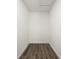 Efficiently designed walk-in closet with wood-look flooring, providing ample storage space at 21269 Edgewater Dr, Port Charlotte, FL 33952