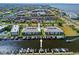 Overhead shot of waterfront condo complex with a shared pool, tennis court, and boat dock at 220 Coldeway Dr # 211, Punta Gorda, FL 33950