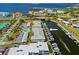 Aerial view of a waterfront condo featuring boat docks, a pool, parking, and landscaping at 220 Coldeway Dr # 211, Punta Gorda, FL 33950
