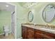 A bathroom showcases a granite countertop double sink vanity, a walk-in shower, and a toilet at 220 Coldeway Dr # 211, Punta Gorda, FL 33950