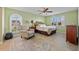 A bedroom featuring an armchair and a wicker headboard bed sits by two windows with plantation shutters at 220 Coldeway Dr # 211, Punta Gorda, FL 33950