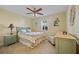A bedroom featuring a bed with floral bedding sits next to a window with plantation shutters at 220 Coldeway Dr # 211, Punta Gorda, FL 33950