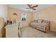 A bedroom features a daybed and desk next to a window with plantation shutters at 220 Coldeway Dr # 211, Punta Gorda, FL 33950