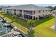 Exterior view of waterfront condo showing lanai, landscaped lawn, and boat dock at 220 Coldeway Dr # 211, Punta Gorda, FL 33950