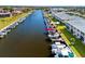 View of canal front condo with boat dock, lanai, and manicured landscaping at 220 Coldeway Dr # 211, Punta Gorda, FL 33950