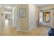 Neutral-toned condo hallway with light tile floors and white doors leading to other rooms at 220 Coldeway Dr # 211, Punta Gorda, FL 33950