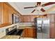 A kitchen showcases stainless steel appliances, wood cabinets, granite countertops, and tile backsplash at 220 Coldeway Dr # 211, Punta Gorda, FL 33950