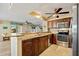 A kitchen showcases granite countertops, wood cabinets, stainless steel appliances, and breakfast bar seating at 220 Coldeway Dr # 211, Punta Gorda, FL 33950
