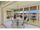 Bright lanai with a waterfront view has sliding glass doors, tile flooring, and a ceiling fan at 220 Coldeway Dr # 211, Punta Gorda, FL 33950