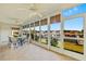 Enclosed lanai showcasing tile floors, ceiling fans, and marina views through large picture windows at 220 Coldeway Dr # 211, Punta Gorda, FL 33950