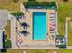 Aerial view of community pool featuring lounge chairs and tables at 220 Coldeway Dr # 211, Punta Gorda, FL 33950