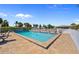 Community pool featuring lounge chairs and tables, ideal for relaxation and entertainment at 220 Coldeway Dr # 211, Punta Gorda, FL 33950