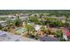 Aerial view showcasing the pool, tennis courts, recreational bowling area, and other community amenities at 2300 Aaron St # 106, Port Charlotte, FL 33952