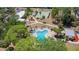 Aerial view of the pool shows the community amenity with beautiful landscaping and lounge chairs at 2300 Aaron St # 106, Port Charlotte, FL 33952