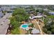 Aerial view showcasing pool, tennis courts, landscaping and community amenities at 2300 Aaron St # 106, Port Charlotte, FL 33952