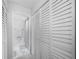 Bathroom with tiled floor, open shower area and plenty of closet storage at 2300 Aaron St # 106, Port Charlotte, FL 33952
