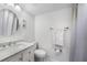 Bright bathroom features a white vanity with marble countertop and a round mirror at 2300 Aaron St # 106, Port Charlotte, FL 33952