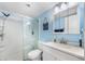 Bathroom with blue walls and a stand up shower with a glass door at 2300 Aaron St # 106, Port Charlotte, FL 33952