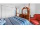 Bedroom featuring a four-poster bed, red chair, and large closet at 2300 Aaron St # 106, Port Charlotte, FL 33952
