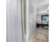 Hallway with closet leading into a light-filled bedroom at 2300 Aaron St # 106, Port Charlotte, FL 33952