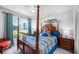 Bedroom with a decorative four-poster bed and natural light at 2300 Aaron St # 106, Port Charlotte, FL 33952