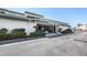 Exterior of the Regency House building, showcasing a well-maintained facade, inviting entrance, and ample parking at 2300 Aaron St # 106, Port Charlotte, FL 33952