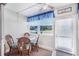 Cozy dining area with wicker chairs and bright natural light at 2300 Aaron St # 106, Port Charlotte, FL 33952