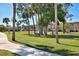 Lush grounds with walking paths, palm trees, and well-maintained landscaping, creating a tranquil and inviting outdoor environment at 2300 Aaron St # 106, Port Charlotte, FL 33952
