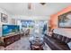 Bright living room with neutral carpet, stylish furniture, and lanai access at 2300 Aaron St # 106, Port Charlotte, FL 33952