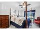 Spacious main bedroom with a four poster bed and blue accents at 2300 Aaron St # 106, Port Charlotte, FL 33952