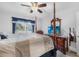 Well-lit main bedroom with a ceiling fan, tv, and view of the community at 2300 Aaron St # 106, Port Charlotte, FL 33952