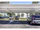 Community parking featuring covered spots, landscaping, and well-maintained grounds at 2300 Aaron St # 106, Port Charlotte, FL 33952