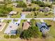 An aerial view of a neighborhood with well-maintained lawns, mature trees, and a variety of single-Gathering homes at 25199 Chiclayo Ave, Punta Gorda, FL 33983