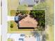 Aerial view of a private home with a large yard, pool, and mature trees, with boundary lines at 25199 Chiclayo Ave, Punta Gorda, FL 33983