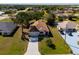 An aerial view of a single-story home with manicured lawn, paved driveway and a two car garage at 25199 Chiclayo Ave, Punta Gorda, FL 33983