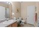 Bathroom features a large vanity with sink, toilet and tile floors, and neutral walls at 25199 Chiclayo Ave, Punta Gorda, FL 33983
