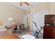 Spare bedroom featuring a desk, closet and workout area with stationary bike and ceiling fan at 25199 Chiclayo Ave, Punta Gorda, FL 33983
