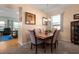 Bright dining area featuring a wooden table, neutral tones, and comfortable seating for six at 25199 Chiclayo Ave, Punta Gorda, FL 33983